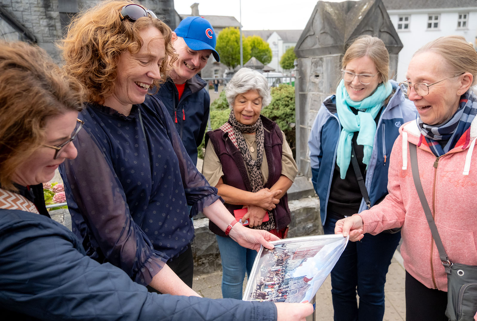 Jane with tour group looking at print of old painting